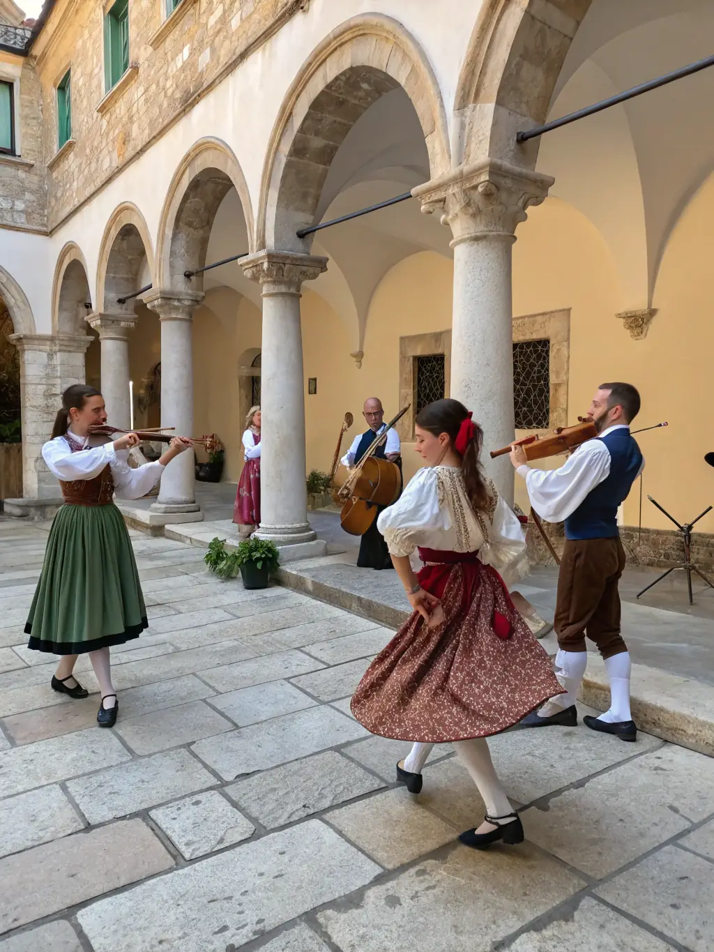 A lively scene from a traditional Breton music performance at the ILLIFEST festival, with musicians playing traditional instruments and dancers showcasing regional folk dances.